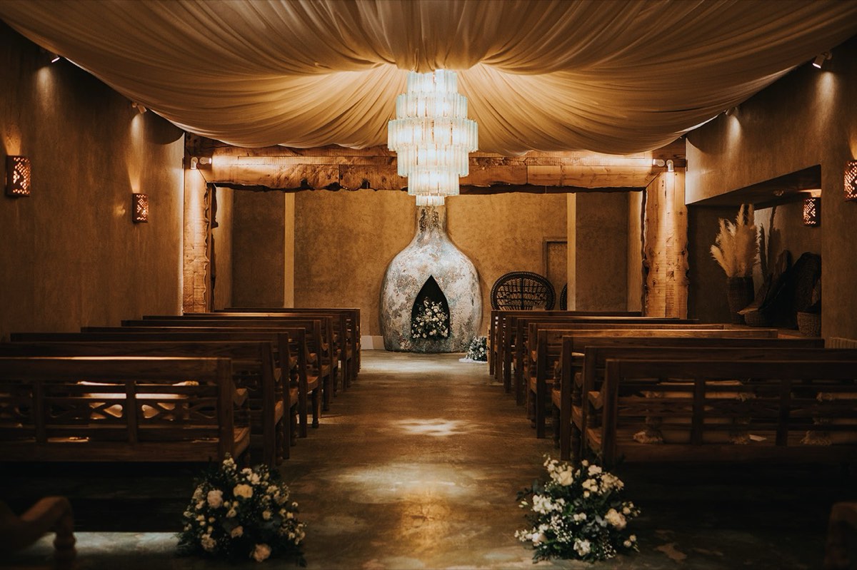 The barn ceremony space at Runa Farm lit for a wedding